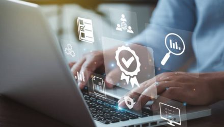 Businessman working on laptops with signs of the top service Quality control certification checked guarantees of the standard of company product. Concept on virtual screen."n"n"n